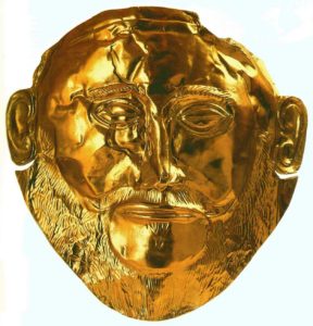 Погребальная маска. 16 век до н. э. Листовое золото; чеканка; гравировка. Национальный музей, Афины. Из гробницы V круга в Микенах.